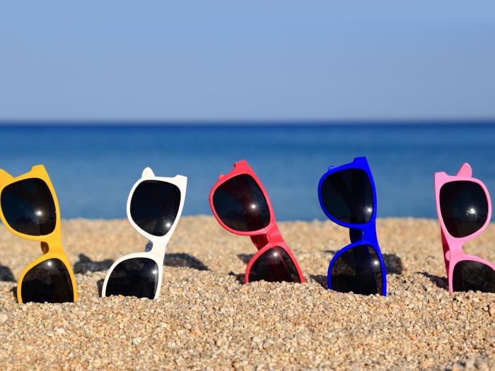 Collection of sunglasses on the beach